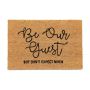 Doormat "Be our guest, but don't expect much" 60x40 cm., light brown/black
