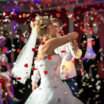 blonde bride dancing at restaurant in flying confetti