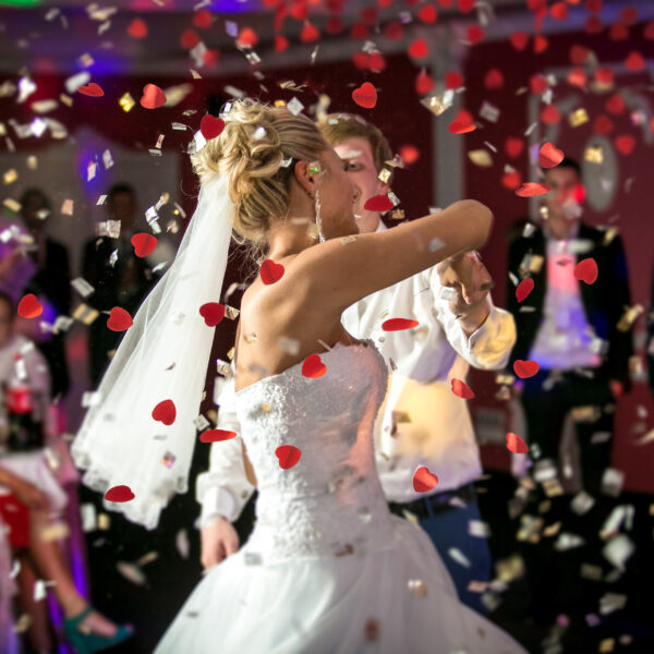 blonde bride dancing at restaurant in flying confetti
