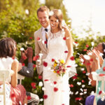 Guests Throwing Confetti Over Bride And Groom At Wedding