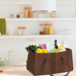 shopping bag full of fresh food on kitchen desk