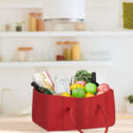 shopping bag full of fresh food on kitchen desk