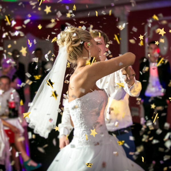 blonde bride dancing at restaurant in flying confetti