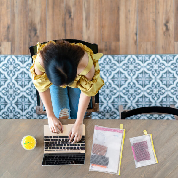 Top view of young asian woman sitting, using laptop in modern wo