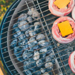 Making home made Beer Can Bacon Burgers on barbecue grill.