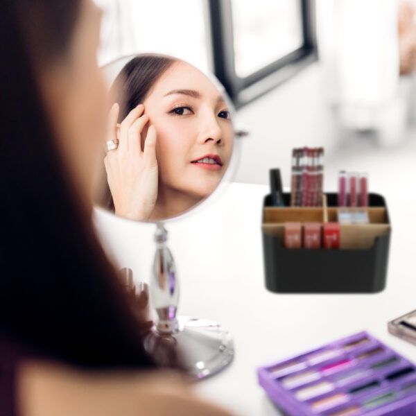 Smiling young beautiful woman fresh healthy skin looking on mirr