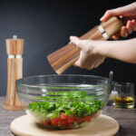 Adding pepper to salad