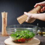 Adding pepper to salad