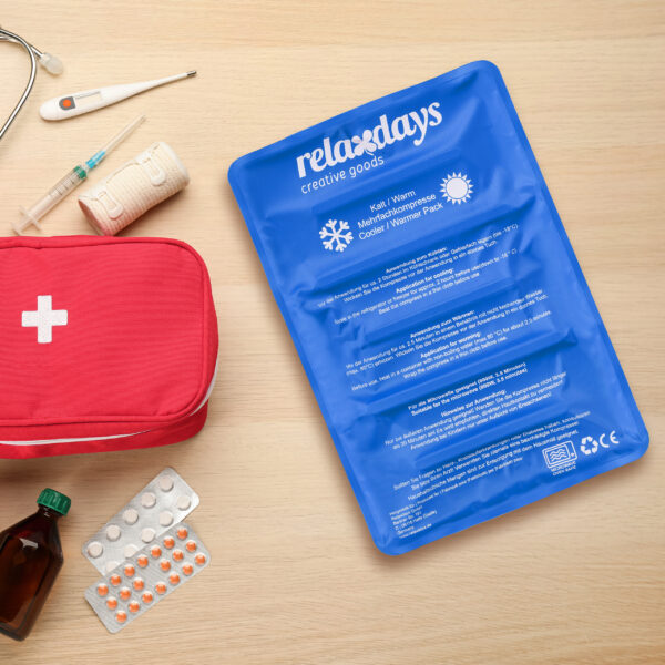 First aid kit on light wooden table, flat lay. Space for text