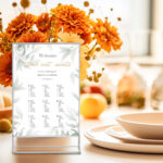 Modern holiday table setting white plate elegant glasses vase with flowers on white table. Concept of autumn holidays