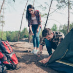Green eco tourism. Young lovely smiling couple wearing casual ch