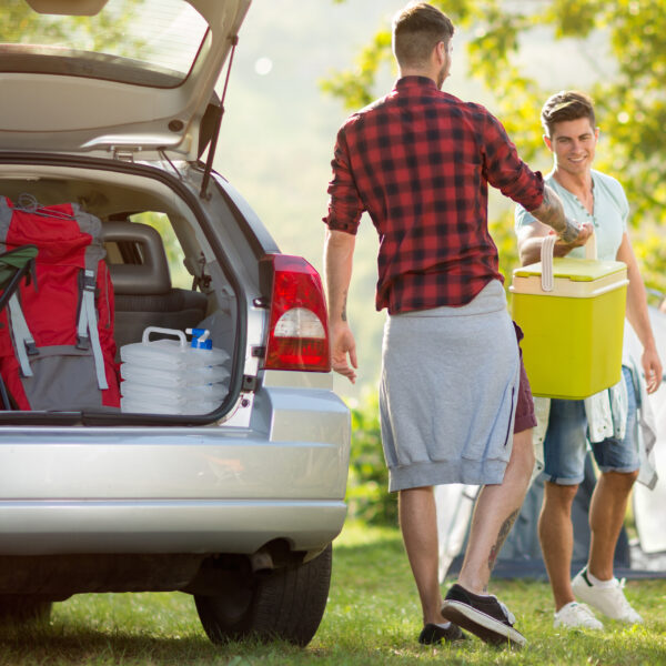 friends unpacking car for camping