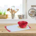 Wooden table top on blurred kitchen interior with copy space