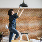 Woman changing lightbulb